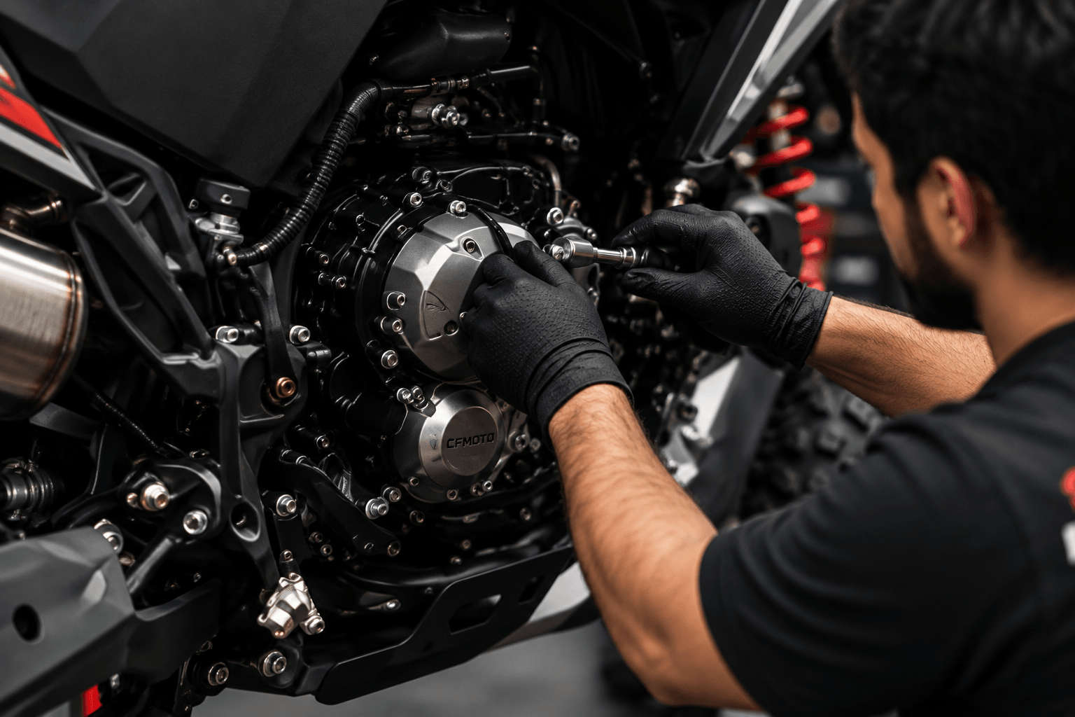 Mechanic working on a motorcycle engine at New Pak Trading Company
